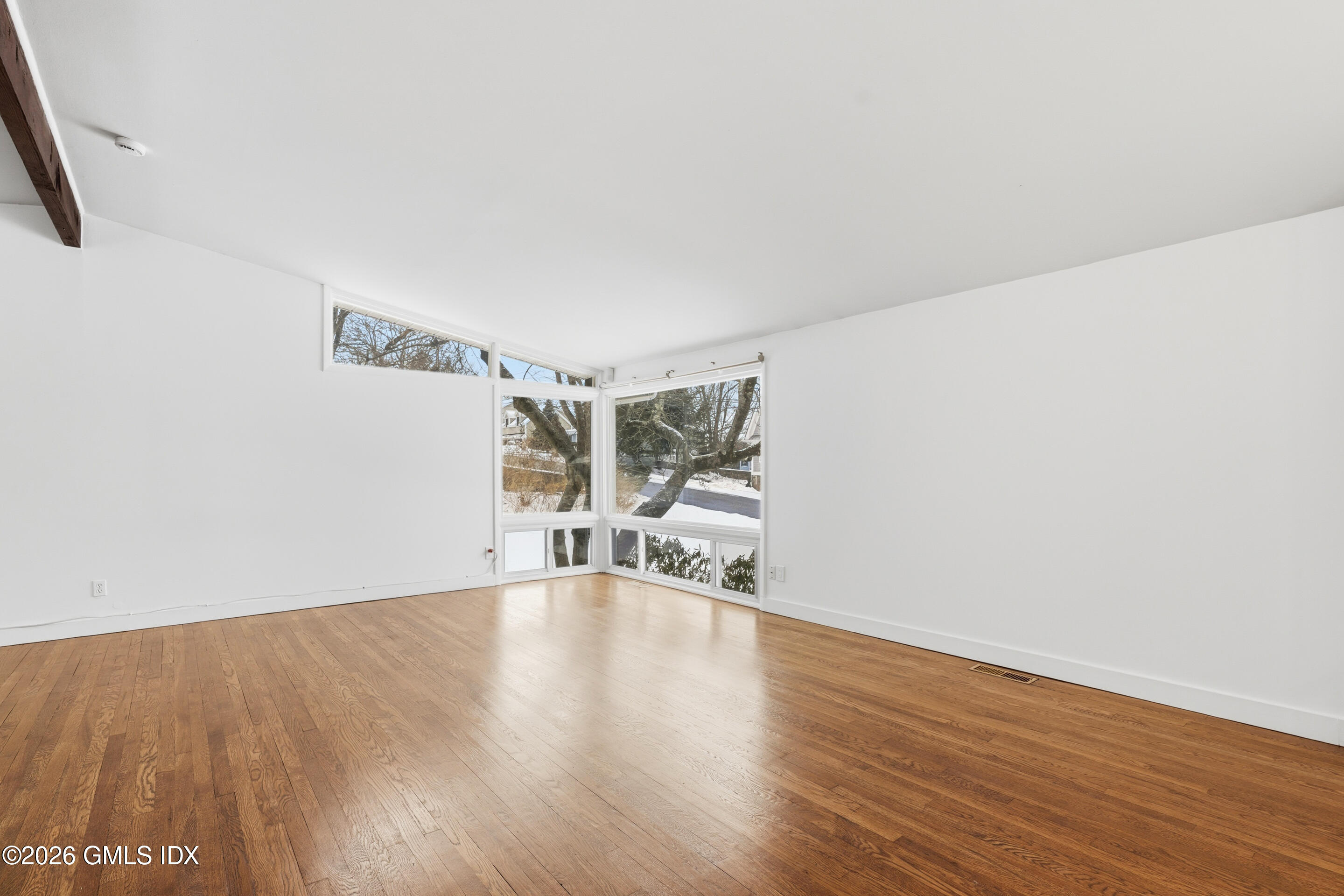 4 Split Timber Place Riverside, CT 06878 - Photo 36 of 38 a view of an empty room with wooden floor and a window