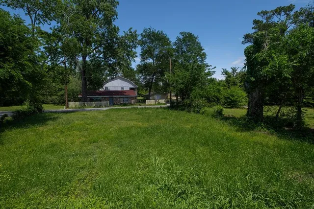 a view of field with trees in the background