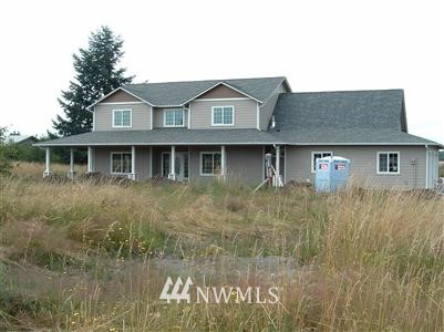 17004 Leitner Road Southwest Rochester, WA 98579 - Photo 1 of 1 a view of a brick house with large windows and a yard