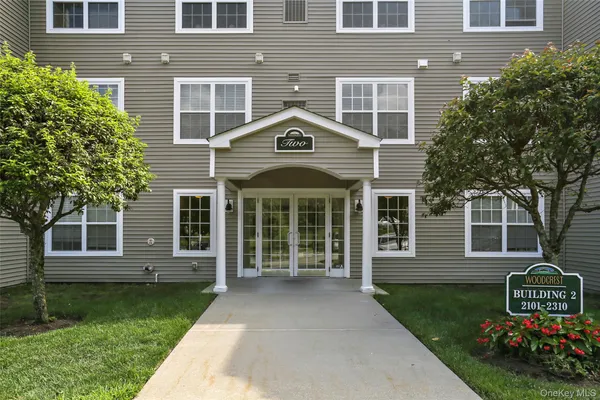 front view of a brick house with a yard