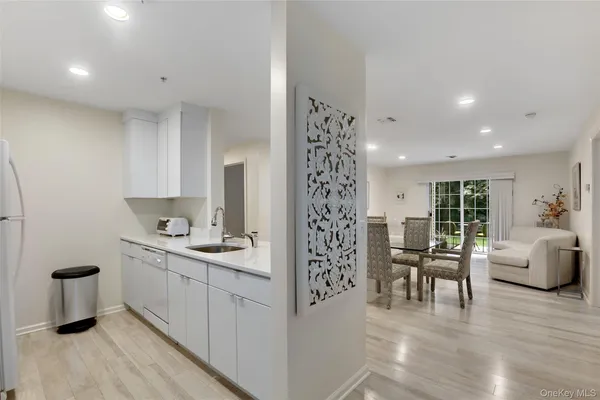 a kitchen with a sink and chairs