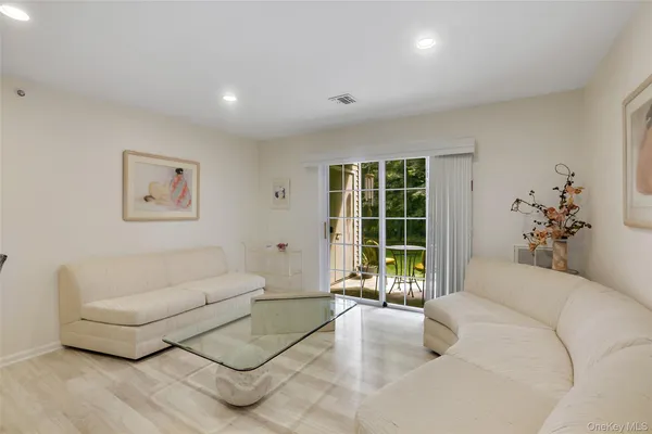 a bedroom with furniture and a large window