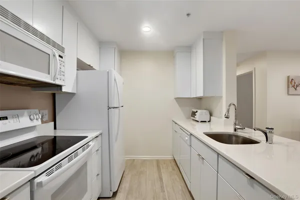 a kitchen with a sink cabinets and stainless steel appliances