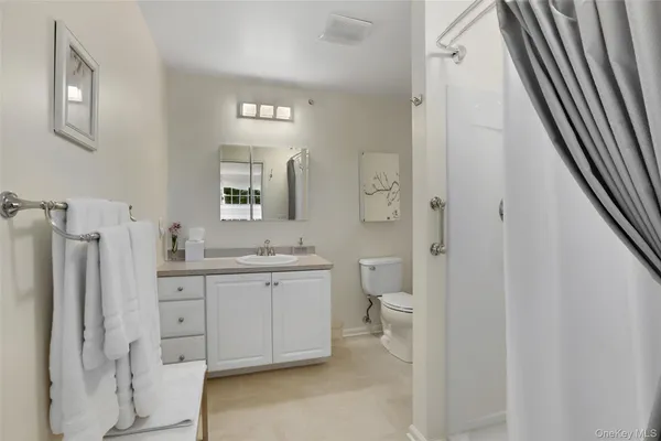 a spacious bathroom with a double vanity sink a mirror and a shower