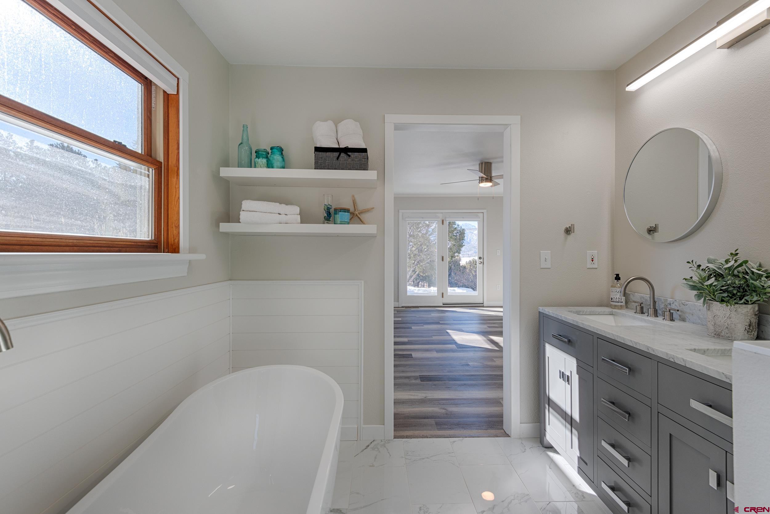 711 Terrace Drive Ridgway, CO 81432 - Photo 18 of 32 a en suite bathroom with a granite countertop sink and a mirror