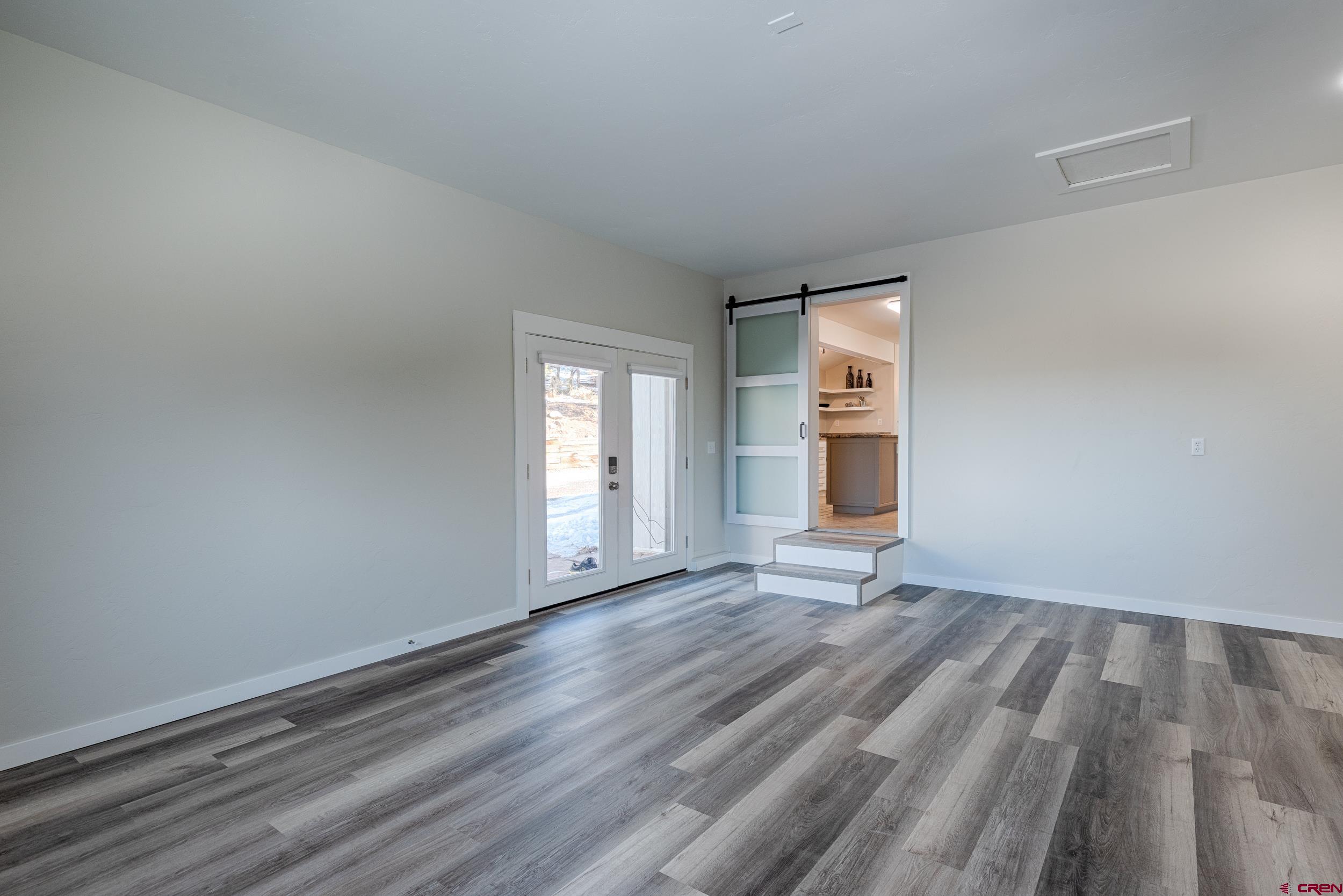 711 Terrace Drive Ridgway, CO 81432 - Photo 23 of 32 an empty room with wooden floor and windows