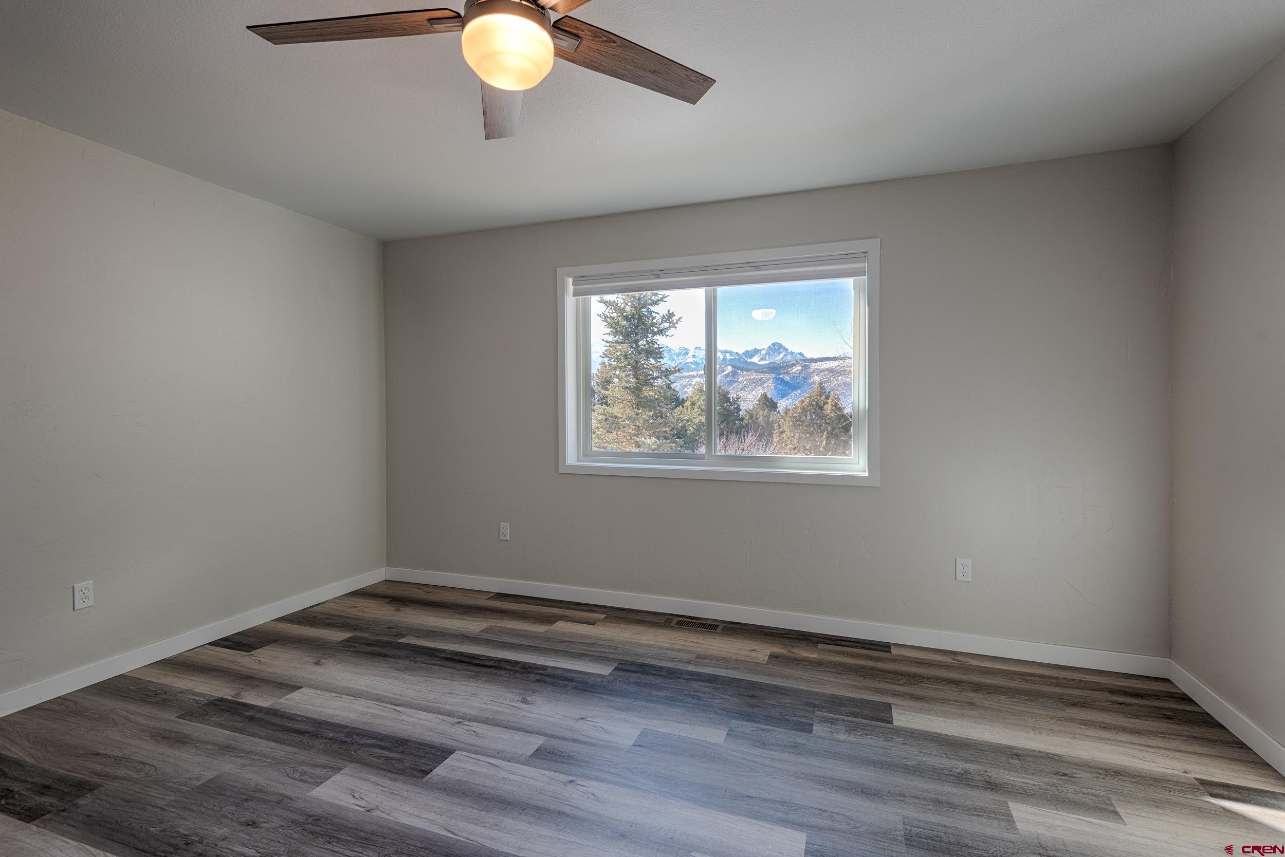 711 Terrace Drive Ridgway, CO 81432 - Photo 24 of 32 a view of wooden floor chandelier and window in a room