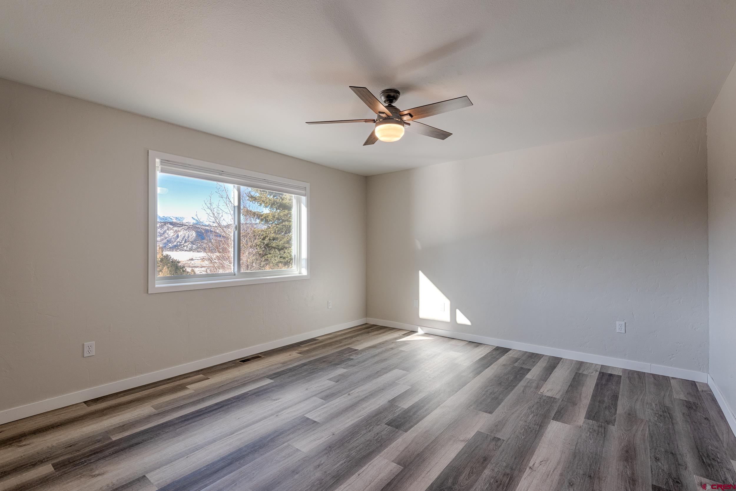 711 Terrace Drive Ridgway, CO 81432 - Photo 25 of 32 a view of empty room with wooden floor and fan