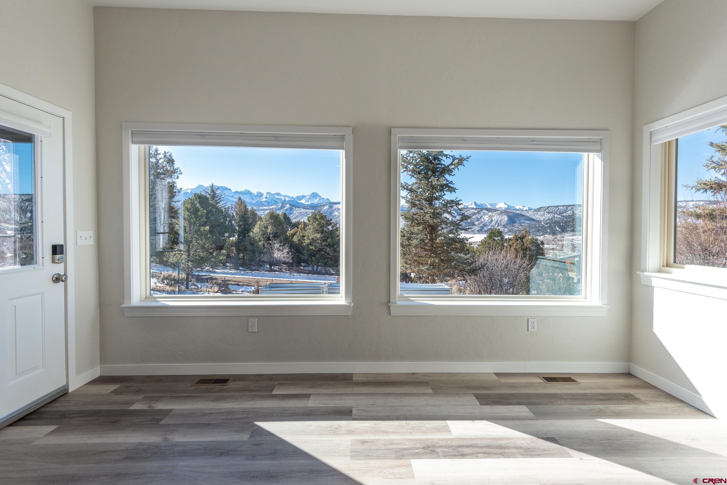 711 Terrace Drive Ridgway, CO 81432 - Photo 26 of 32 an empty room with wooden floor and a window