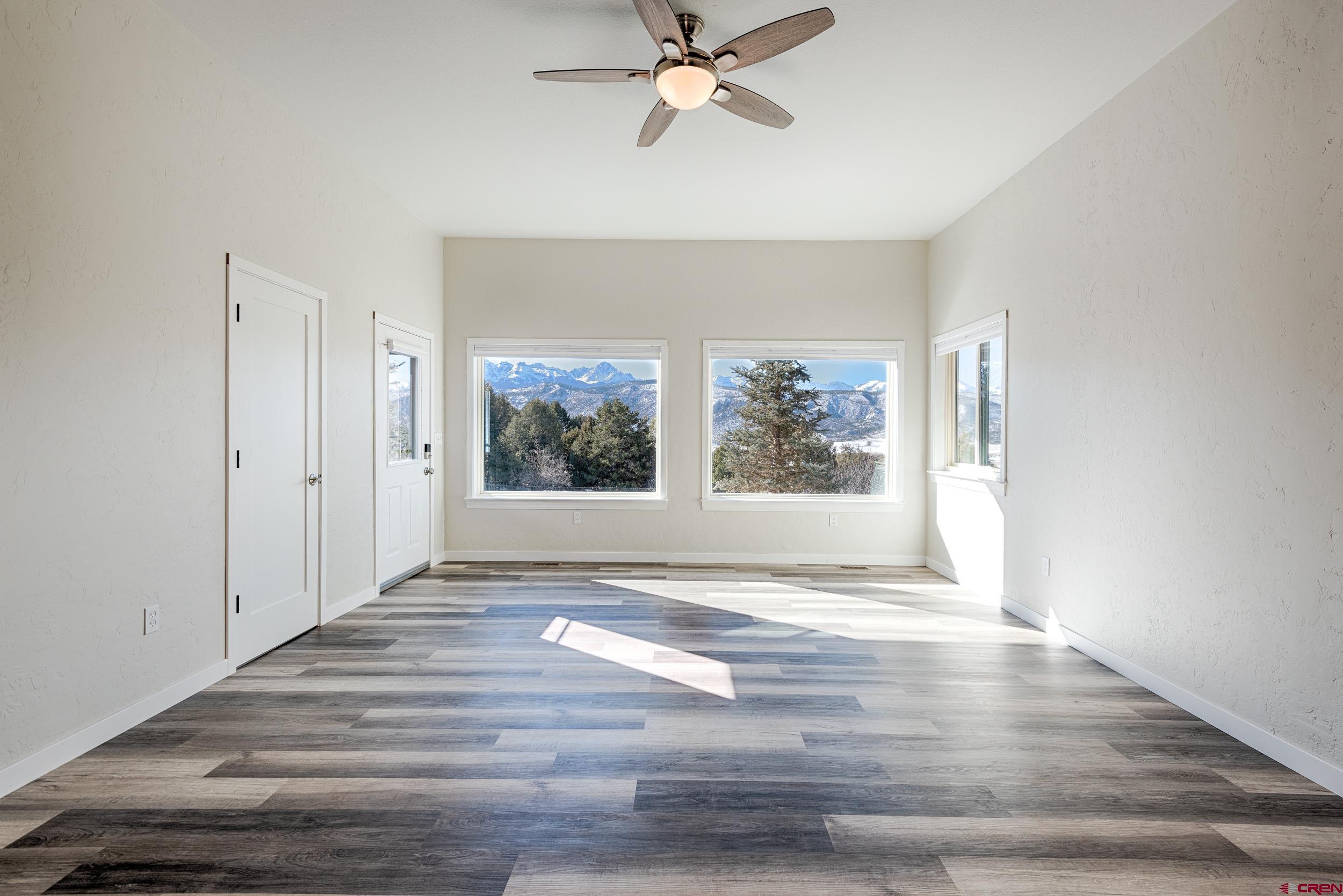 711 Terrace Drive Ridgway, CO 81432 - Photo 27 of 32 a view of an empty room with a window and wooden floor