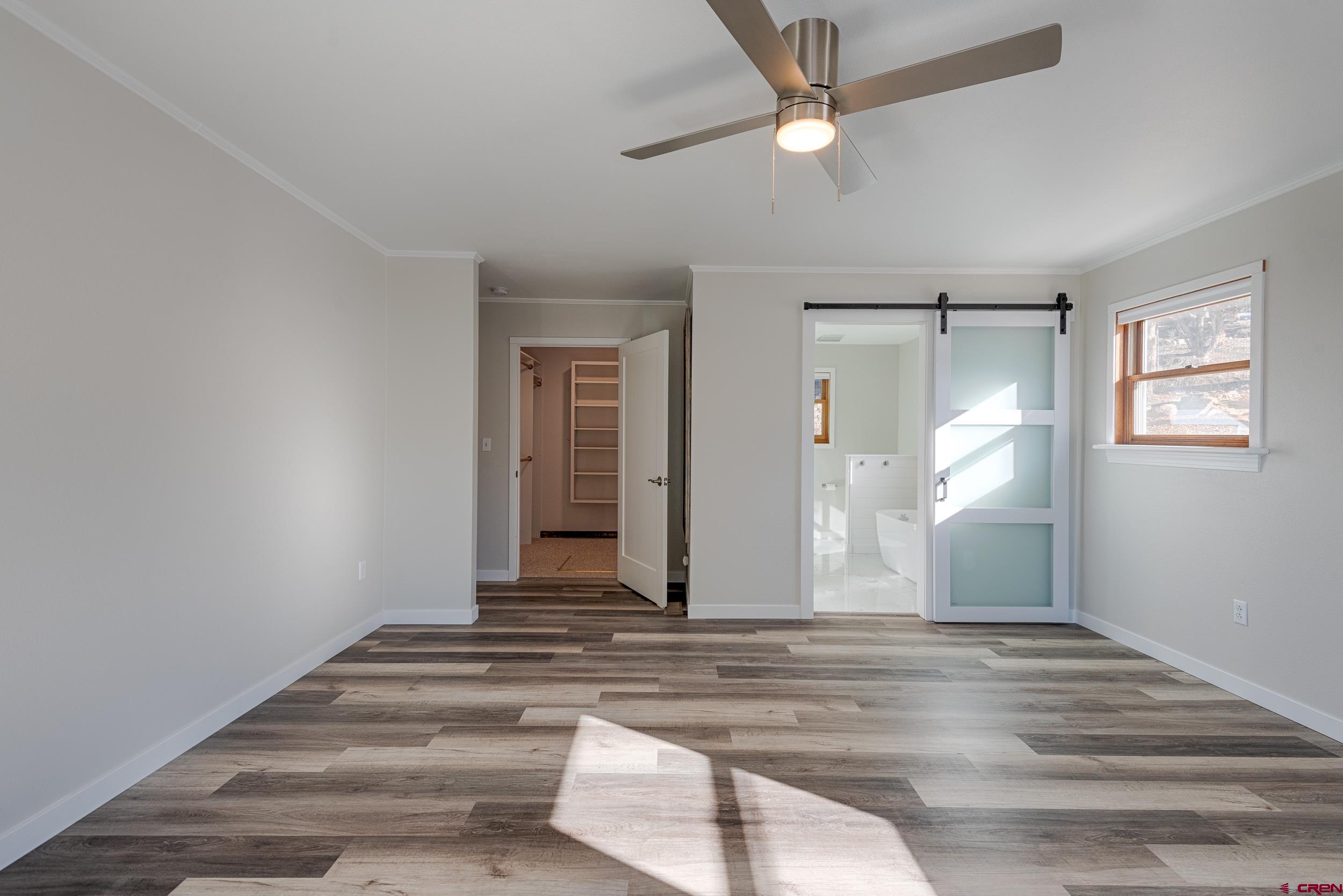 711 Terrace Drive Ridgway, CO 81432 - Photo 30 of 32 an empty room with wooden floor fan and windows