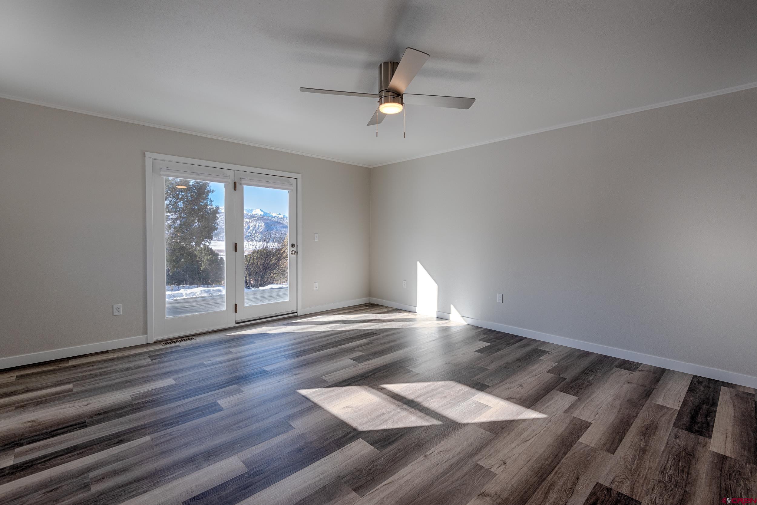 711 Terrace Drive Ridgway, CO 81432 - Photo 31 of 32 wooden floor in an empty room with a window
