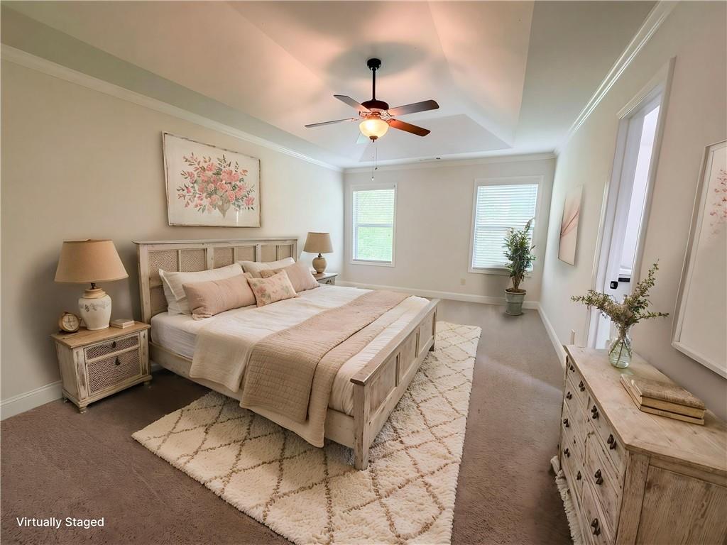 1948 Paynes Point Winder, GA 30680 - Photo 4 of 22 a spacious bedroom with a bed and a chandelier