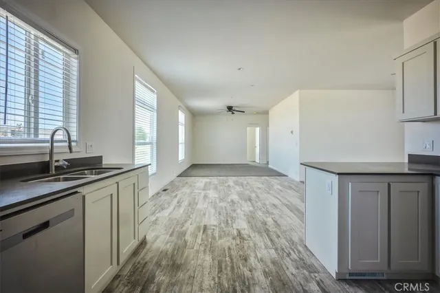 an empty room with a window and a ceiling fan