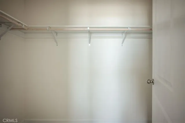 a big room with a kitchen and refrigerator