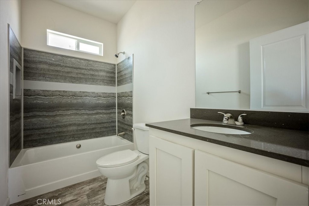 12076 Lager Road Phelan, CA 92371 - Photo 21 of 30 a bathroom with a granite countertop sink toilet and shower
