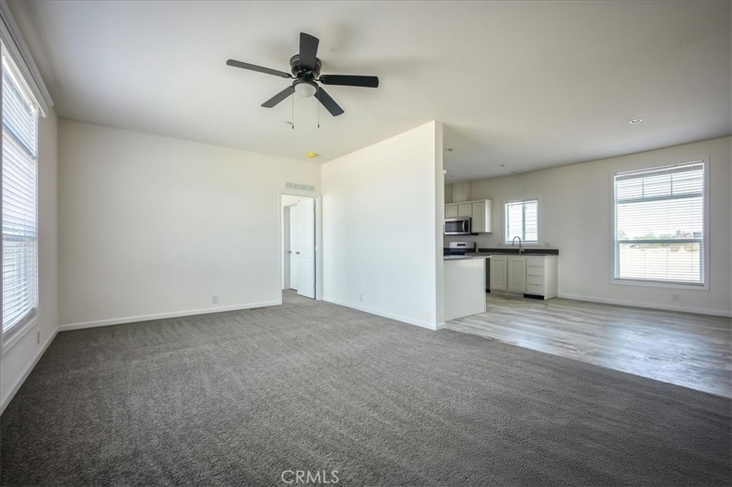12076 Lager Road Phelan, CA 92371 - Photo 5 of 30 a view of an empty room with a window and a kitchen
