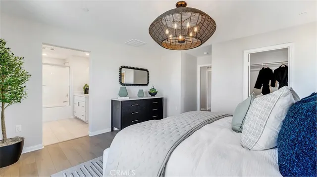 a bedroom with bed and a chandelier