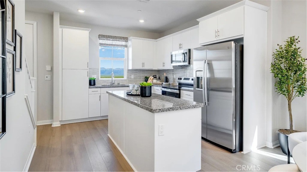 1210 Yeager Avenue Rialto, CA 92376 - Photo 3 of 24 a kitchen with stainless steel appliances granite countertop a refrigerator a sink a stove a washer and dryer
