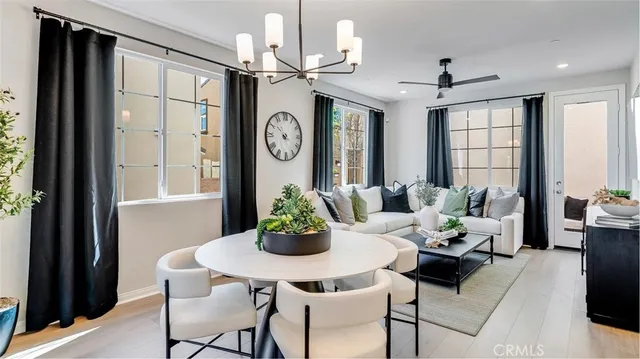 a dining room with furniture window and wooden floor