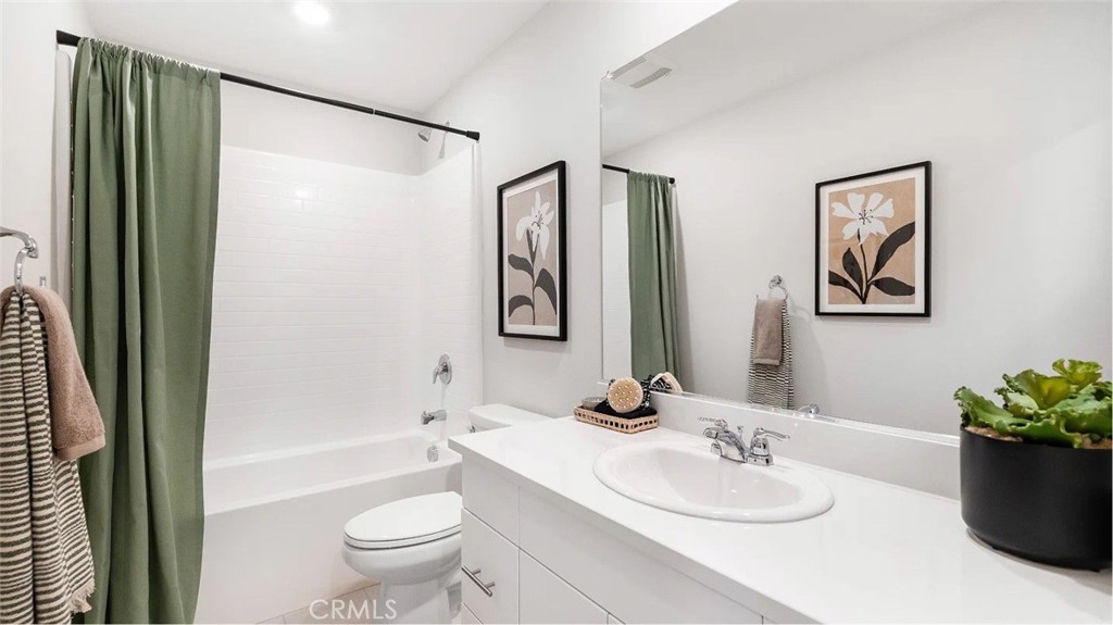 1210 Yeager Avenue Rialto, CA 92376 - Photo 8 of 24 a bathroom with a granite countertop sink toilet and shower
