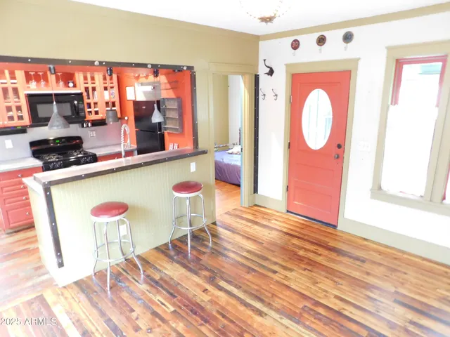 a room with wooden floor and outdoor seating