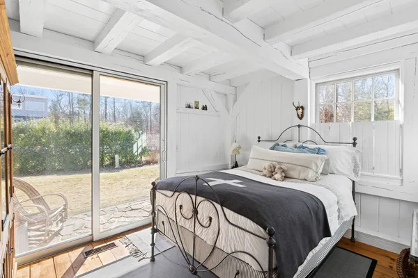 a bedroom with a large bed and a balcony view