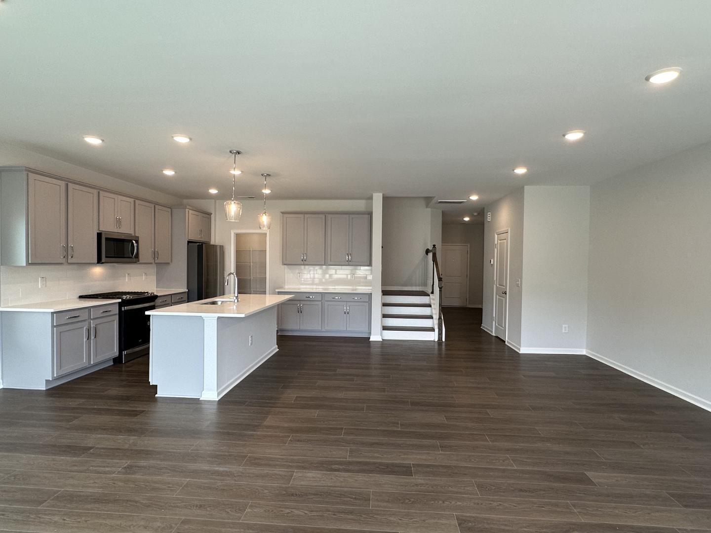 3114 Ranger Drive Durham, NC 27703 - Photo 11 of 33 a large kitchen with stainless steel appliances a large counter top and a fireplace