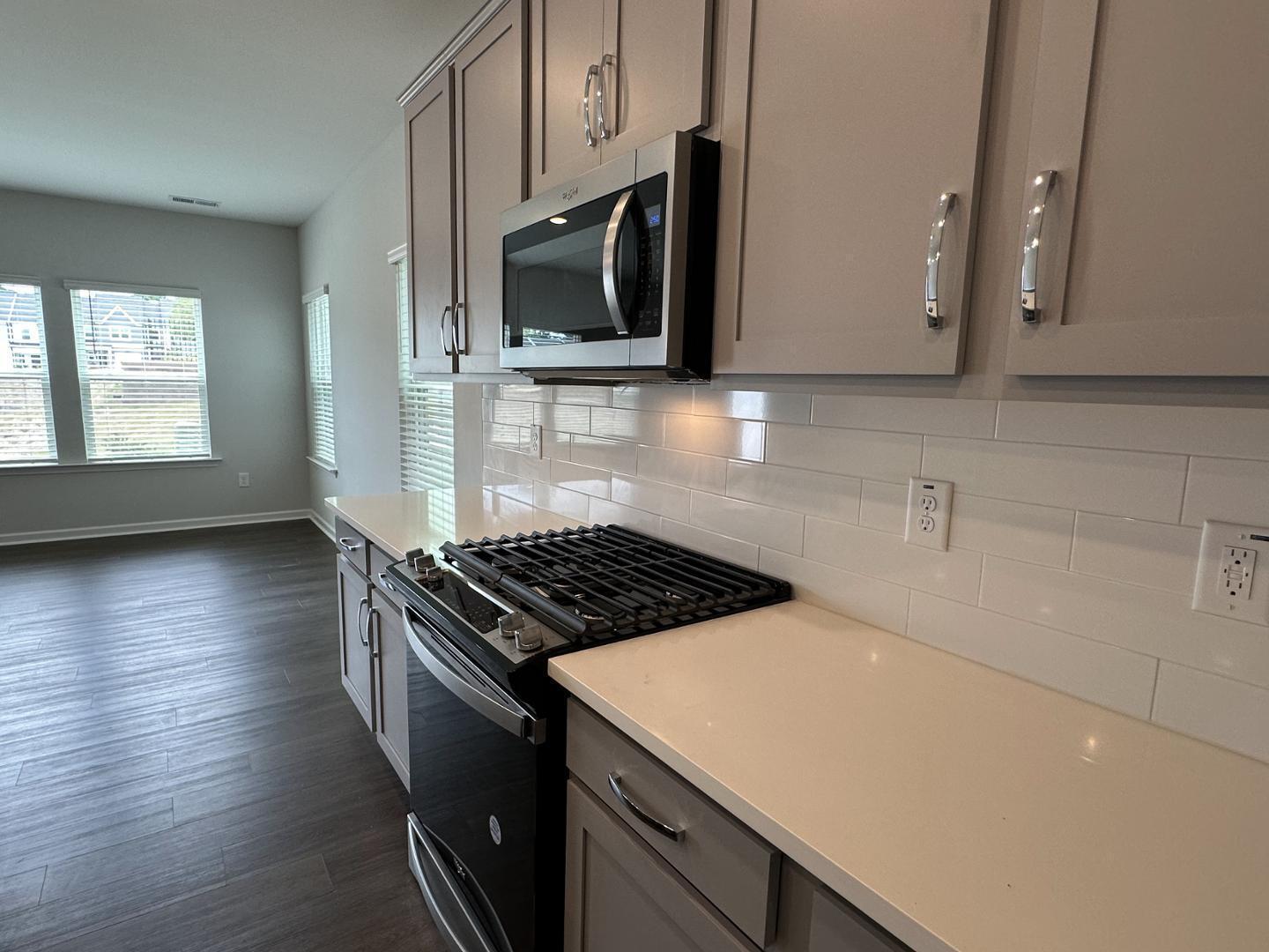 3114 Ranger Drive Durham, NC 27703 - Photo 13 of 33 a kitchen with granite countertop a stove and a microwave