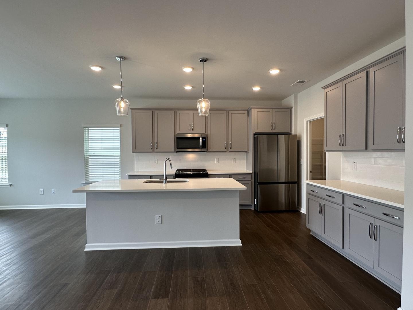3114 Ranger Drive Durham, NC 27703 - Photo 14 of 33 a kitchen with stainless steel appliances a refrigerator sink and wooden cabinets