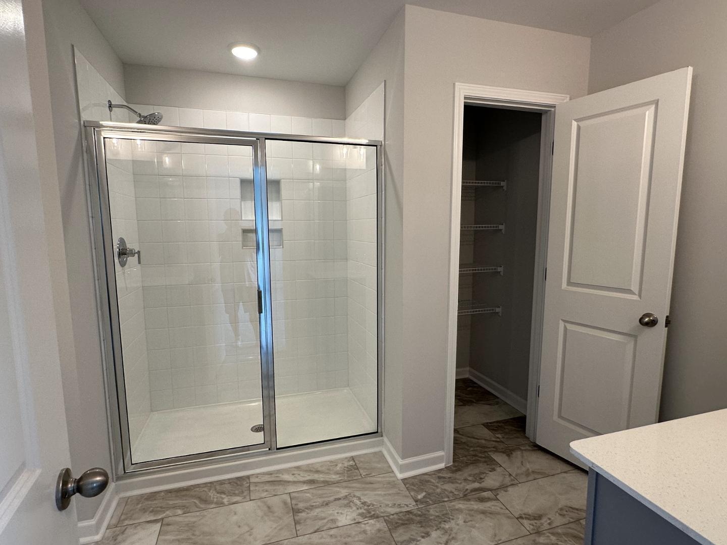 3114 Ranger Drive Durham, NC 27703 - Photo 21 of 33 a bathroom with a glass shower door