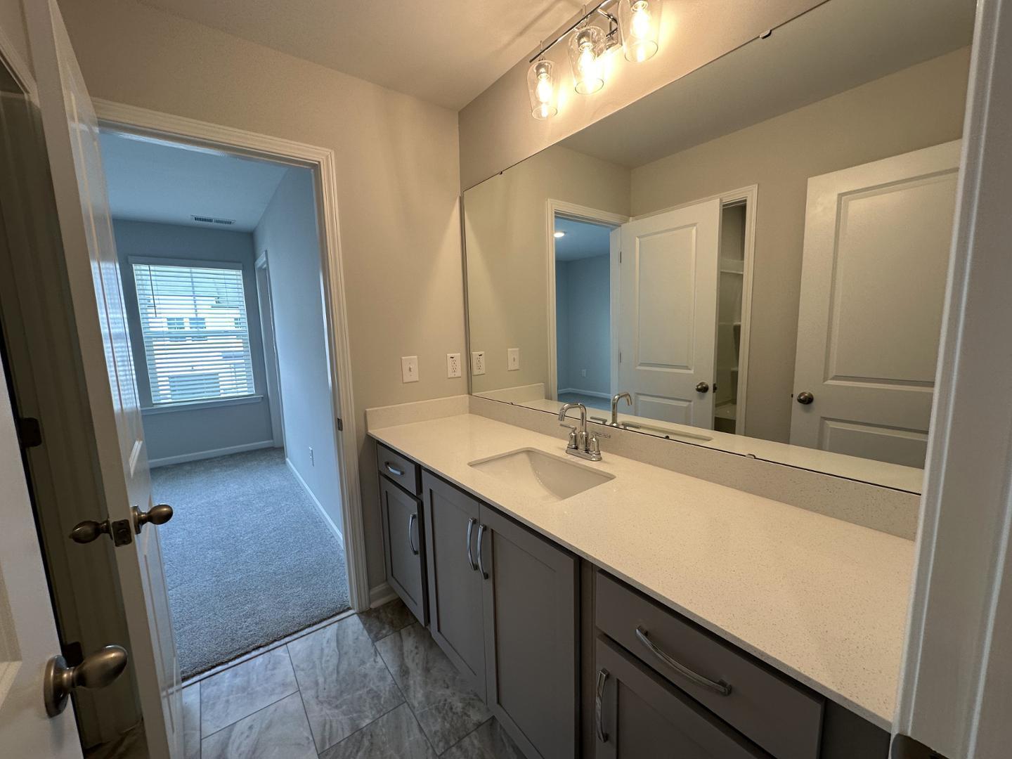 3114 Ranger Drive Durham, NC 27703 - Photo 27 of 33 a en suite bathroom with a sink double vanity and a mirror