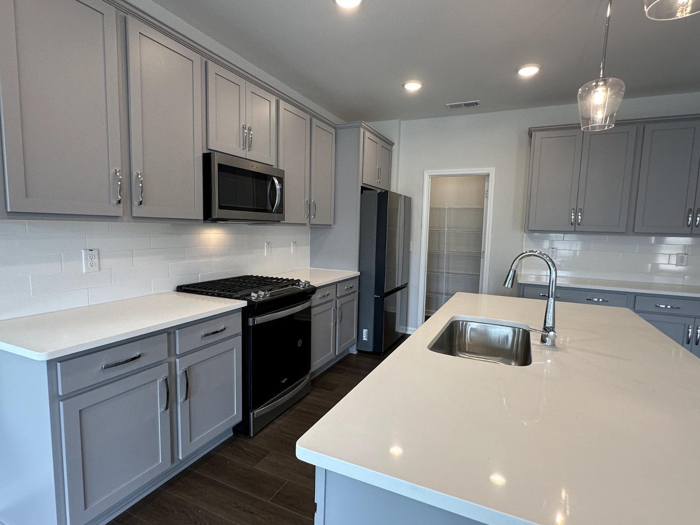 3114 Ranger Drive Durham, NC 27703 - Photo 7 of 33 a kitchen with stainless steel appliances a refrigerator sink and microwave