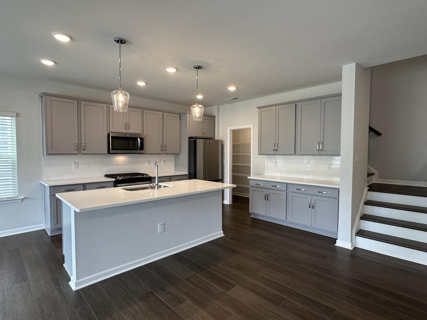 3114 Ranger Drive Durham, NC 27703 - Photo 9 of 33 a kitchen with a stove a sink and a refrigerator