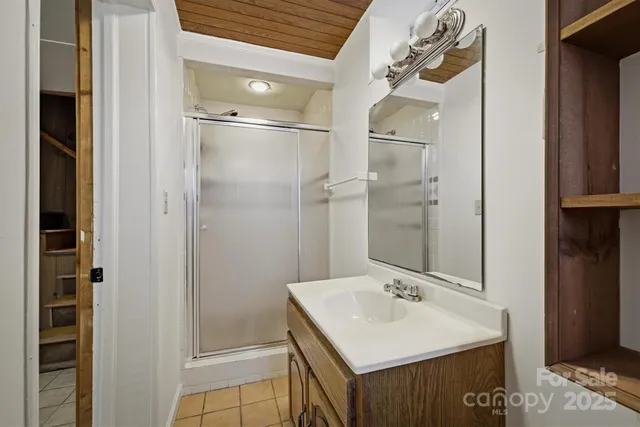 a bathroom with a sink a mirror and a shower