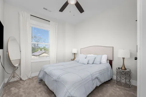 a bedroom with a bed and a ceiling fan
