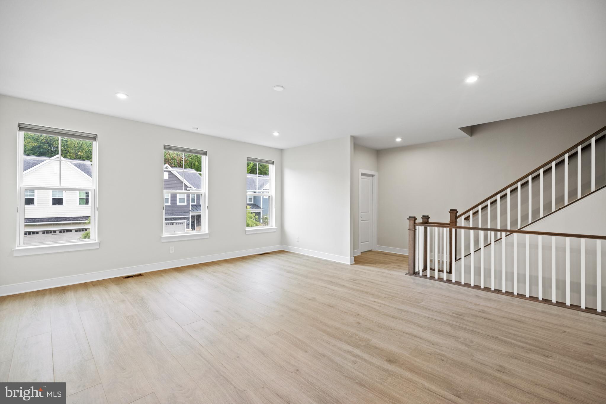 1548 Meadowlark Glen Road Dumfries, VA 22026 - Photo 13 of 48 a view of an empty room with wooden floor and a window