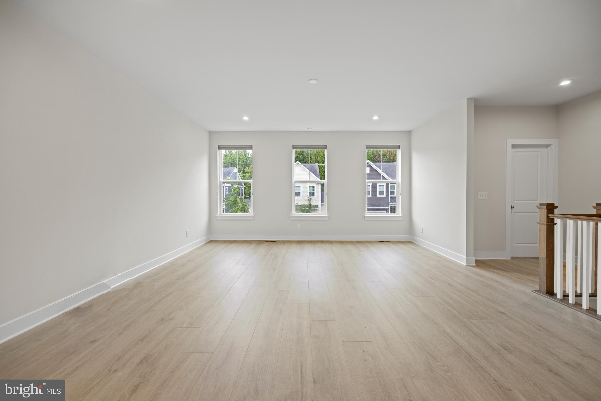 1548 Meadowlark Glen Road Dumfries, VA 22026 - Photo 14 of 48 an empty room with wooden floor and windows