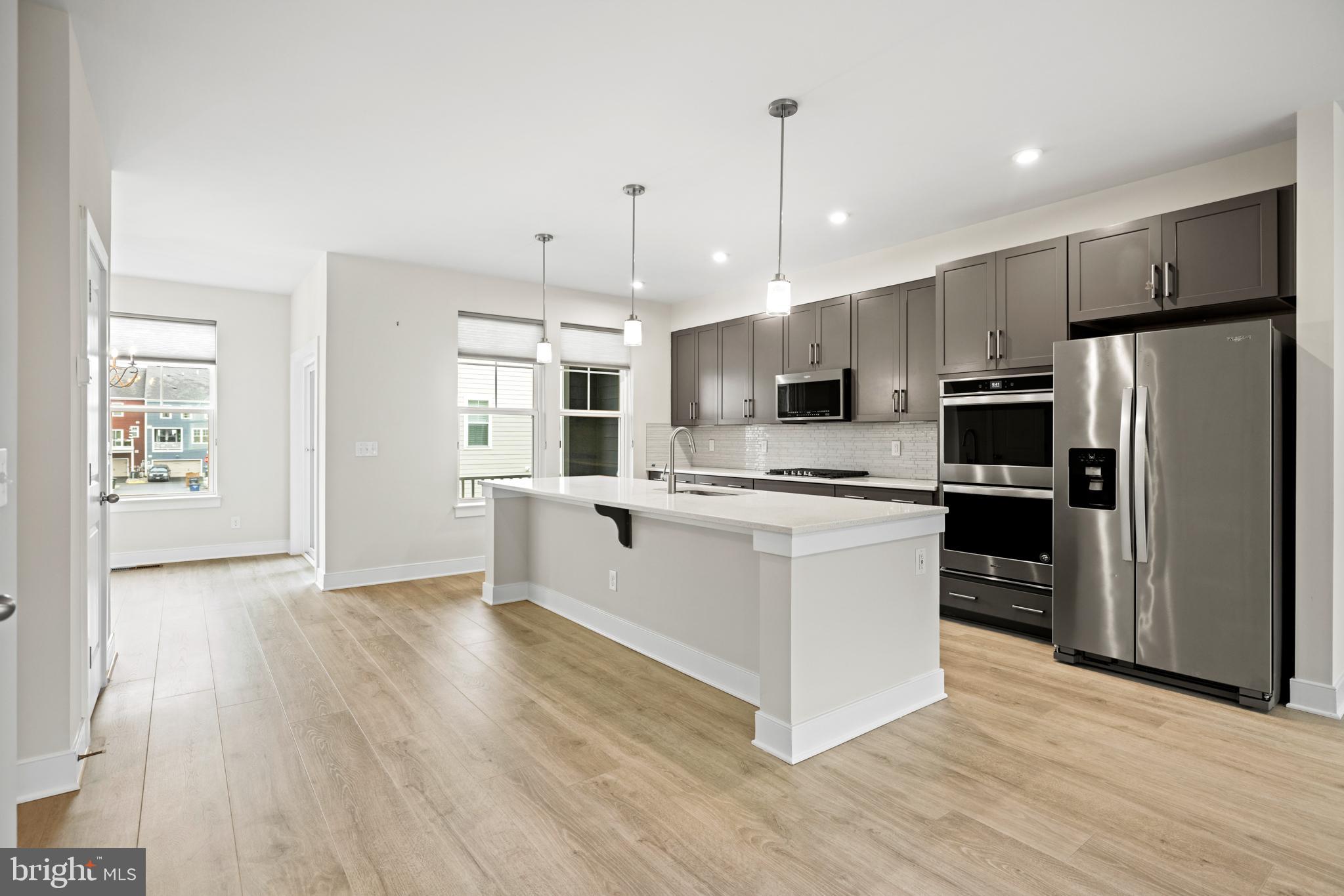 1548 Meadowlark Glen Road Dumfries, VA 22026 - Photo 15 of 48 a kitchen with stainless steel appliances a refrigerator and a wooden floor