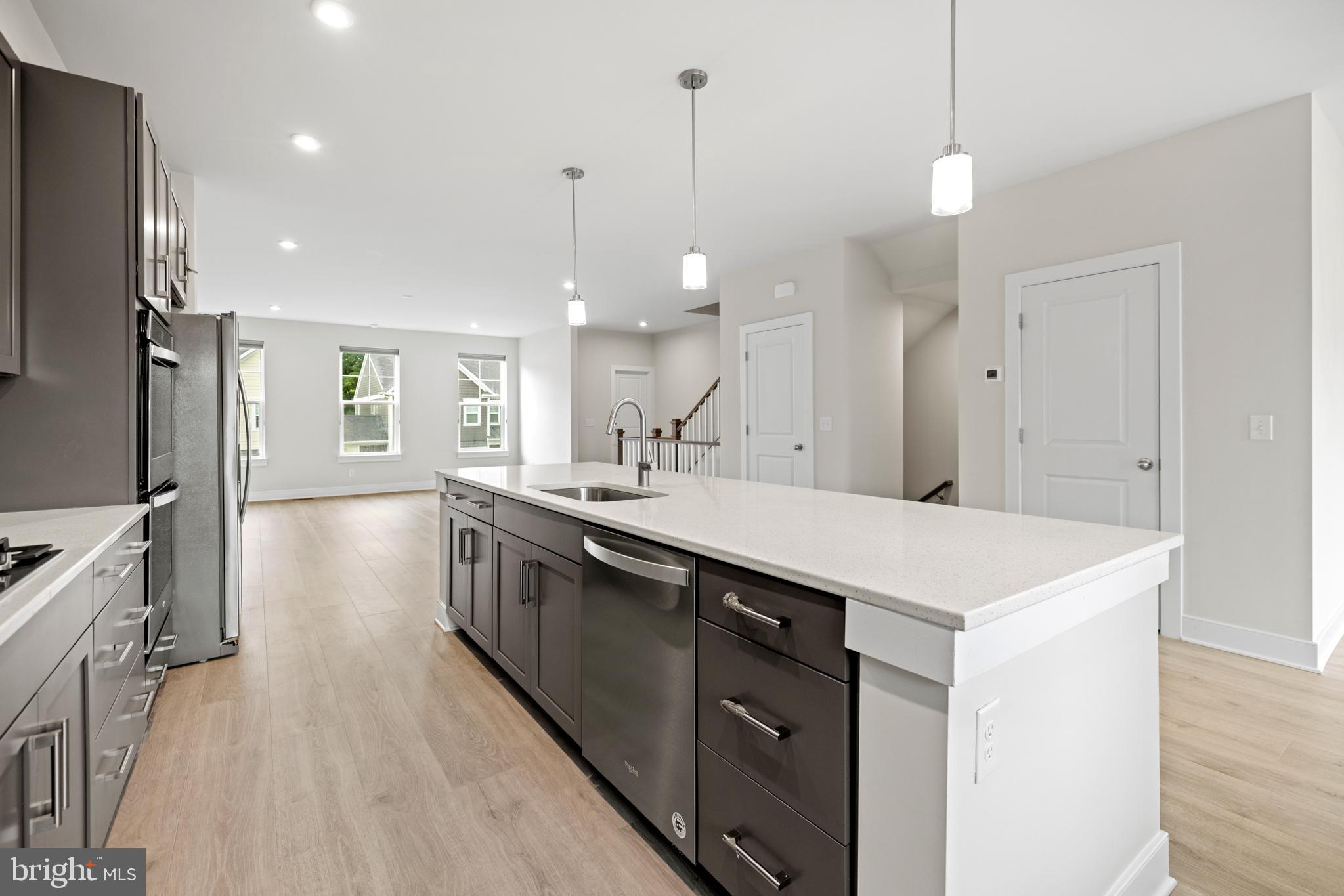 1548 Meadowlark Glen Road Dumfries, VA 22026 - Photo 18 of 48 a kitchen with a sink a counter top space stainless steel appliances and a center island