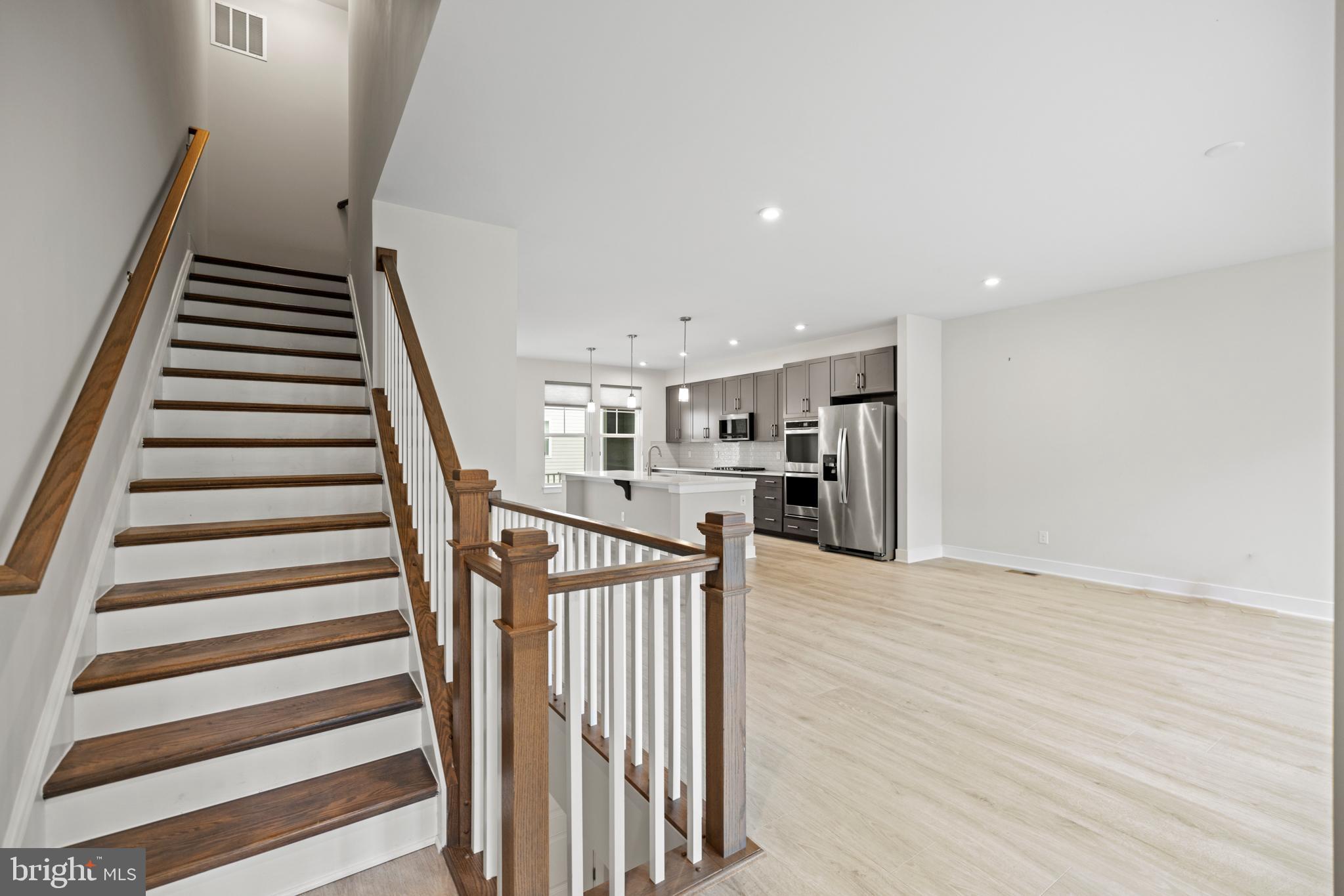 1548 Meadowlark Glen Road Dumfries, VA 22026 - Photo 23 of 48 a view of a kitchen with wooden floor and stairs