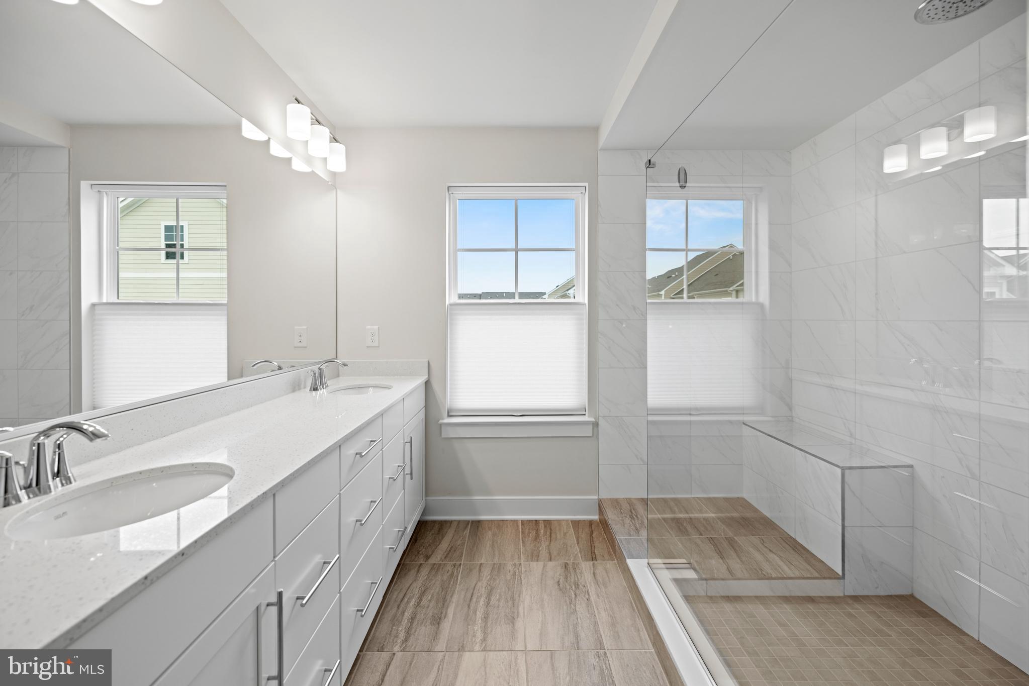 1548 Meadowlark Glen Road Dumfries, VA 22026 - Photo 29 of 48 a bathroom with a sink a mirror and a shower