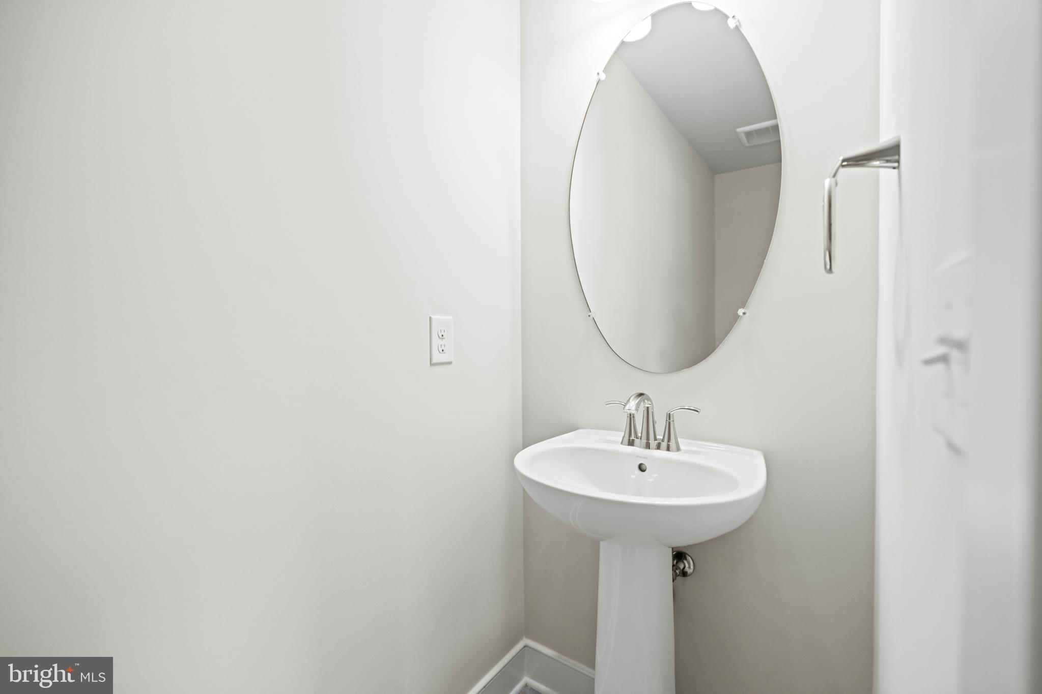 1548 Meadowlark Glen Road Dumfries, VA 22026 - Photo 40 of 48 a bathroom with a sink and a mirror