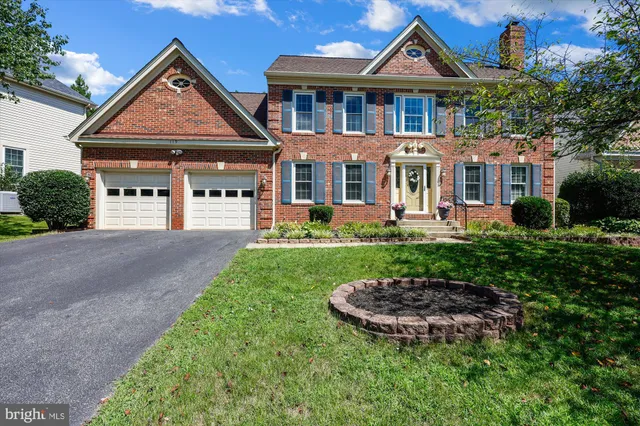 a front view of a house with a yard table and chairs