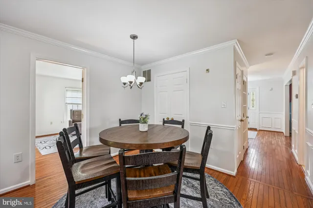a view of a hallway with wooden floor and stairs