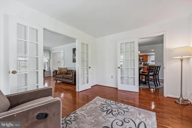 a view of a workspace with furniture and wooden floor