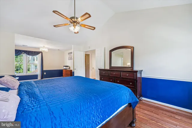 a view of a patio with couches table and chairs under an umbrella