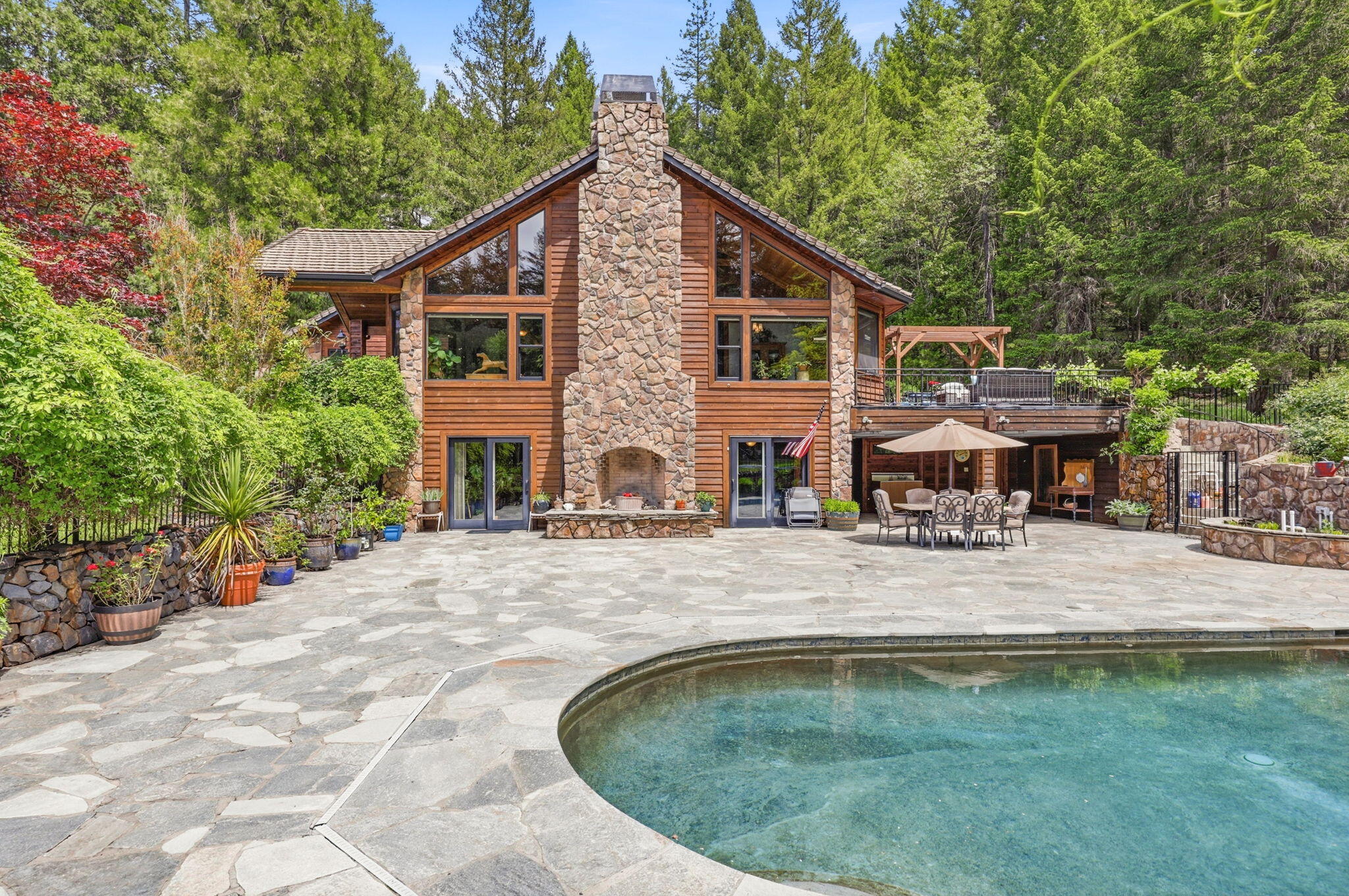 985 Elliott Creek Road Wilderville, OR 97543 - Photo 57 of 98 a swimming pool with outdoor seating and yard