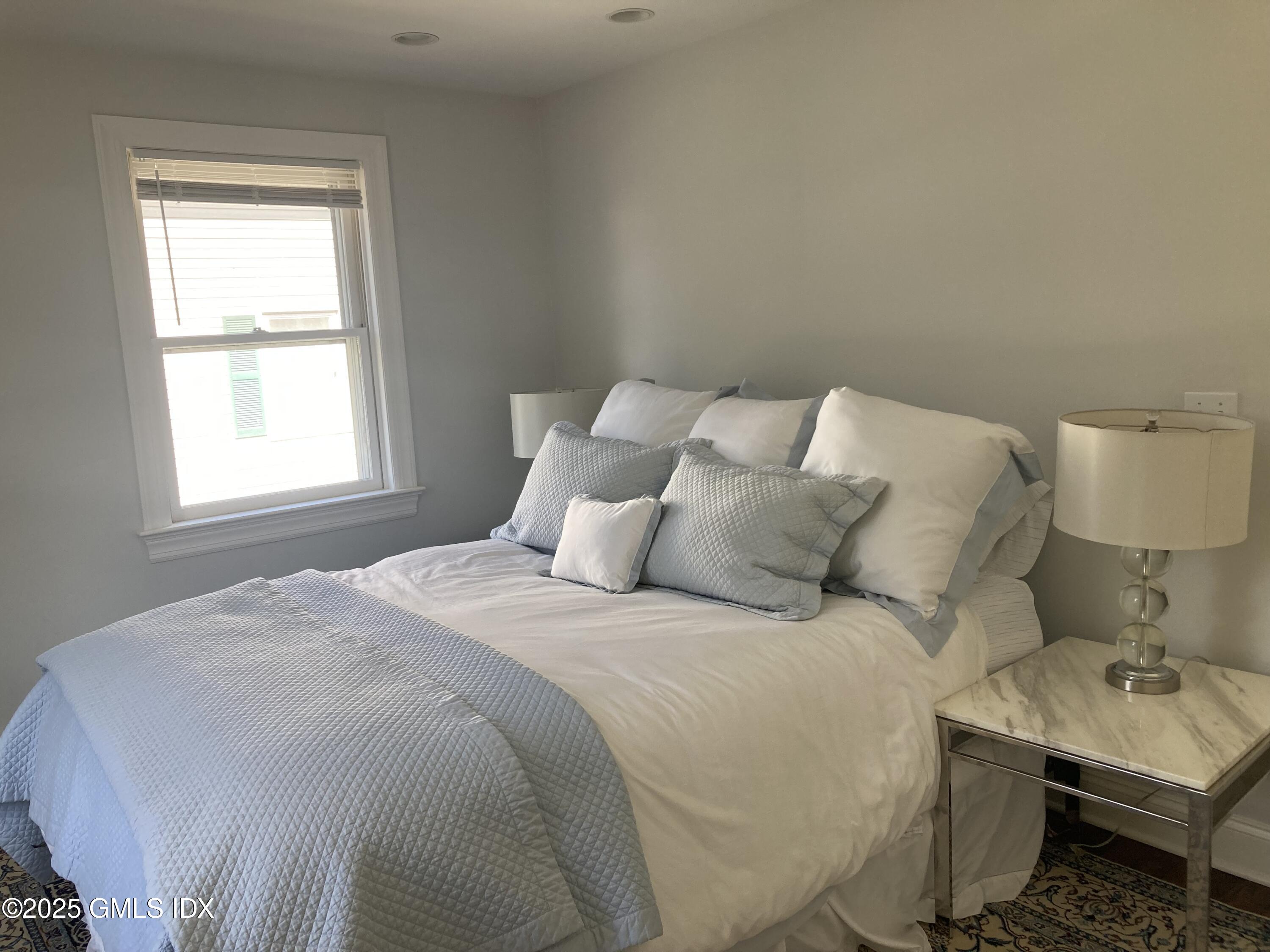 51 Northfield Street, Unit B Greenwich, CT 06830 - Photo 12 of 13 a large bed sitting in a bedroom next to a window