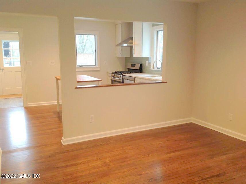 51 Northfield Street, Unit B Greenwich, CT 06830 - Photo 4 of 13 a view of a kitchen with wooden floor and a window